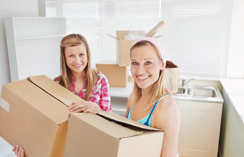 Professional movers loading items into a van in Hornsey